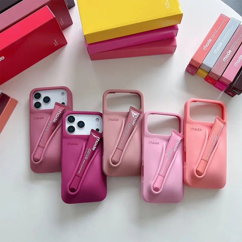 Pink Rhode phone cases with a brand logo on a white surface