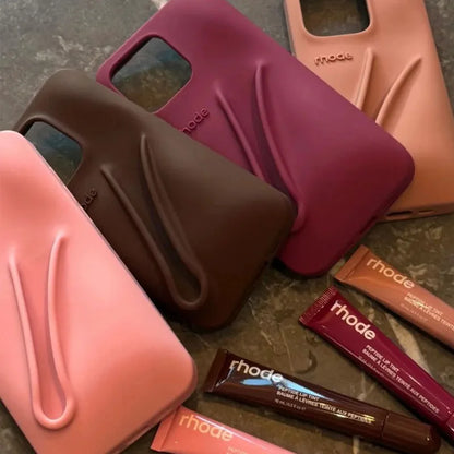 Collection Rhode of phone cases and lip products with 'rhode' branding on a textured surface.