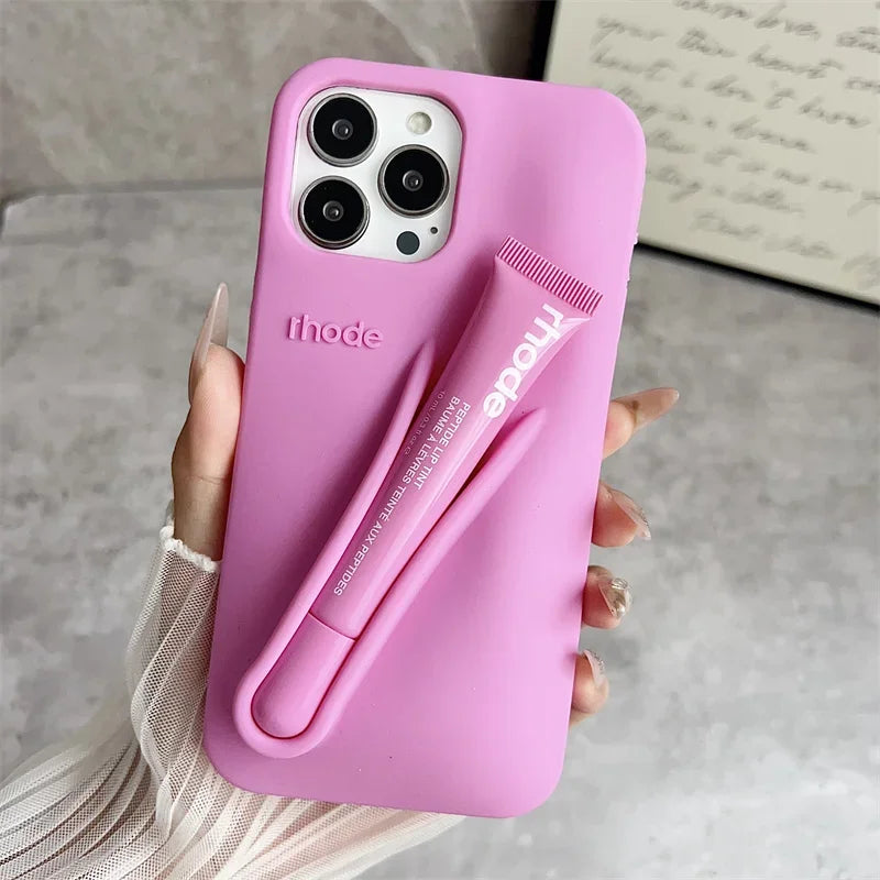 Pink Rhode phone case with a pen holder held by a hand on a neutral background