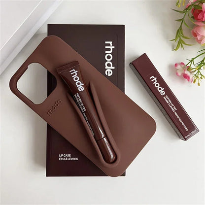 Brown Rhode lip case with lip balm and lipstick on a white surface with 'rhode' branding.