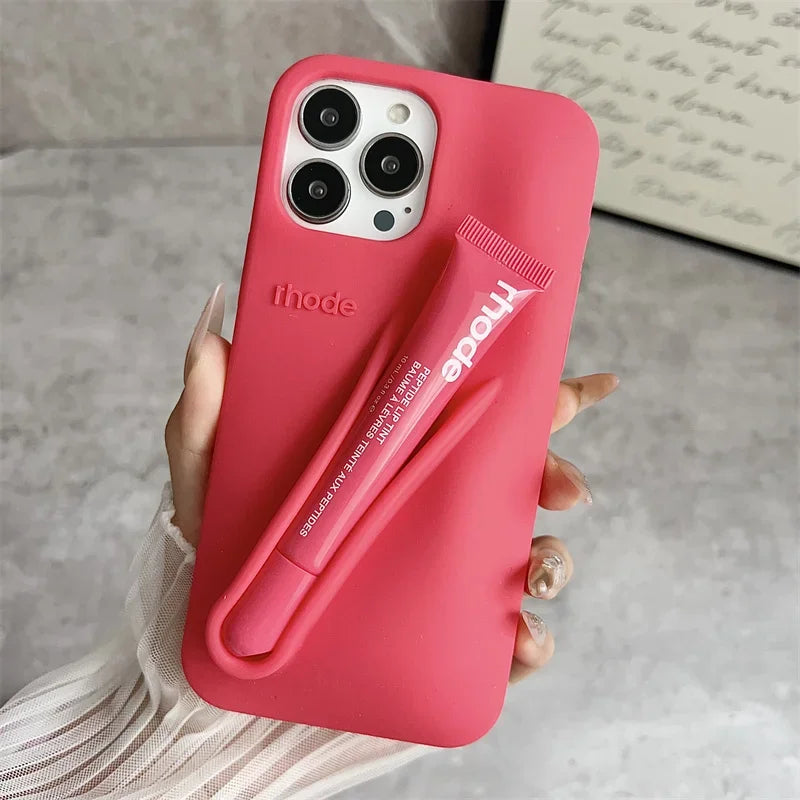 Red Rhode phone case with a pen holder and 'ihode' branding held by a hand.