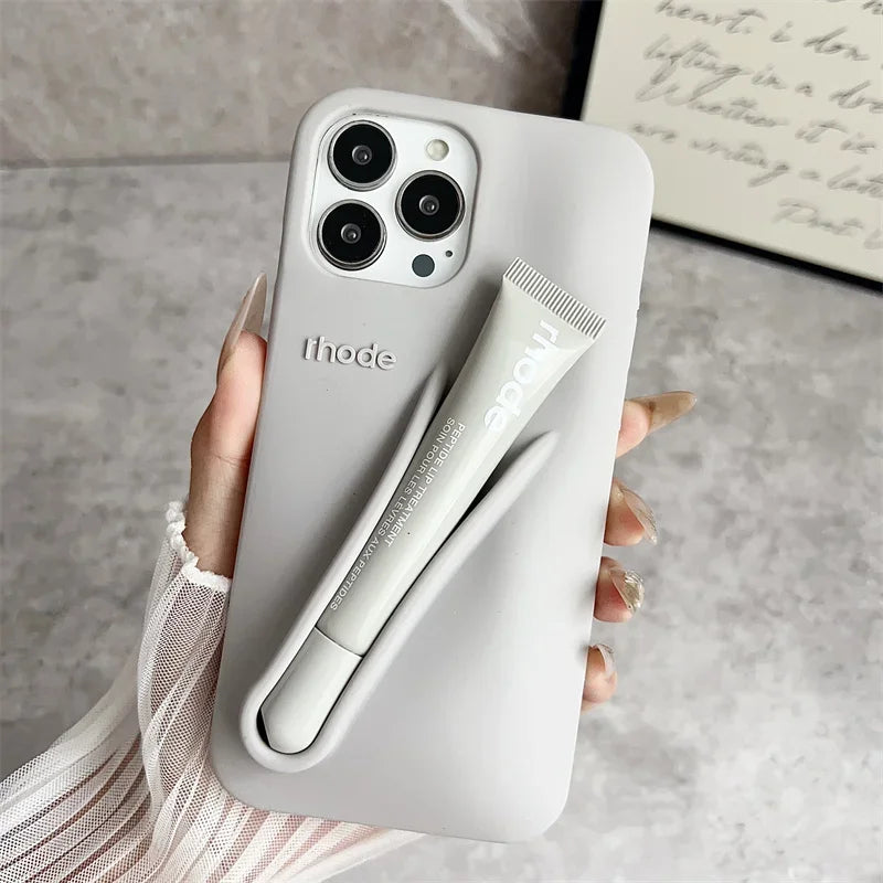 Rhode Phone case with built-in stylus held by a hand on a neutral background